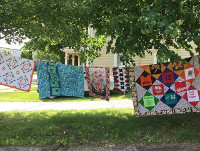CT Quilts Hanging Outside